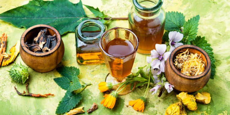 Herbal remedies,Assorted dried herbs including rosemary sprigs, hibiscus flowers, and ginseng roots arranged on wooden surface for natural hair care remedies