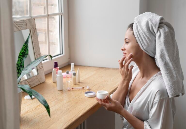 Daily skincare routine products including cleanser, serum, moisturizer, and sunscreen arranged on a bathroom counter